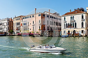 Motorboat on Grand canal. Foscari Palace, Palazzo Barbaro. Sunny day in Venice