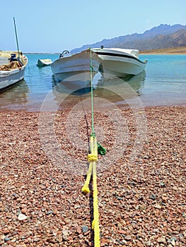 Motorboat mooring on the Red Sea coast. Nautical and navigation through extreme landscapes
