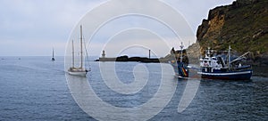 Motorboat and sailboat, fishing boat on the coast of the Cantabrian Sea