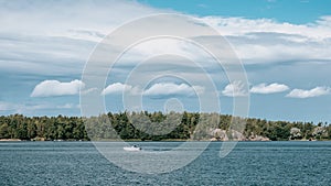 A motorboat sailing the sea on the Ãland Islands on a summer day