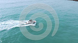 Motorboat Sailing In The Turquoise Sea Making Foamy Waves In Benidorm, Spain