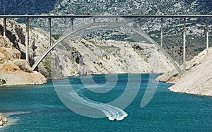 Motorboat under highway bridge