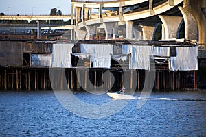 Motorboat on the Willamette River with old docks concrete overpass