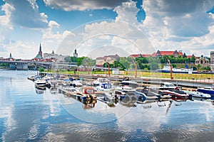Motorboats moored in marina with view on Pomeranian Dukes Castle and cathedral in Szczecin