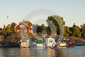 Motorboats moored to archipelago cliff