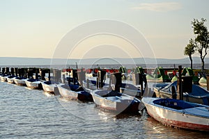 Motorboats and pedal boats docked at the footbridge