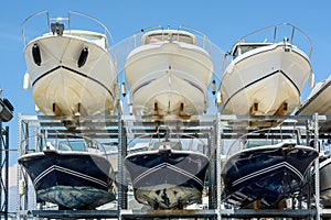 Motorboats racked one above another in a dry rack boat storage facility