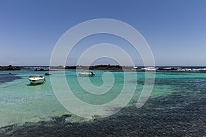 Motorboats turquoise water tropical island.