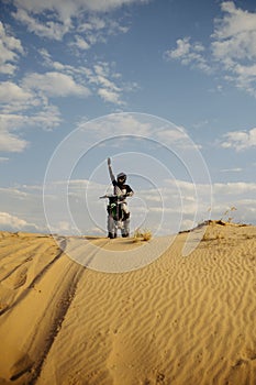 Motorcross rider with raised hand front view