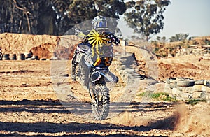 Motorcycle, action and balance, person on race track for adrenaline and stunt with extreme sports outdoor. Competition