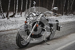 Motorcycle against the backdrop of a winter forest