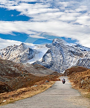 Motorcycle bike on mountain road in the Alps, Valle d`Aosta, Italy, Europe. Motorbiker travelling, active lifestyle, adventure