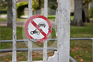 Motorcycle and car prohibited traffic road sign No motorbike auto no parking panel red white front gate street