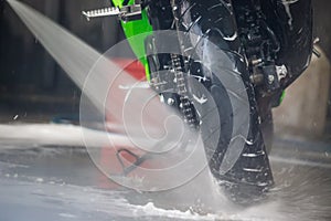 Motorcycle clean service. Employees are washing motorbikes.