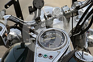 Motorcycle dashboard and steering wheel, view from driver seat.