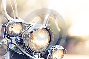 Motorcycle detail with headlamps in foreground