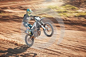 Motorcycle, dirt track stunt and air jump in desert, sand trail and freedom. Driver, cycling and offroad freedom, sports