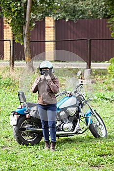 Motorcycle driver wearing helmet before start driving