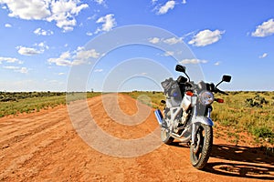 Motorcycle on an empty dirt road Outback Australia