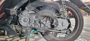 The motorcycle engine that is being opened is in the chain section behind the motorcycle during the service process.