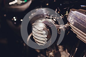 Motorcycle engine, metallic background with exhaust pipes.