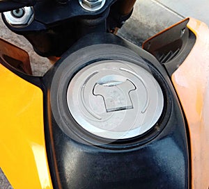 Motorcycle fuel oil tank cap on cement floor background closeup