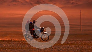 On a motorcycle in the Gobi desert. Dust from under the wheels. Wild Mongolian road. 06.09.2019. Gobi Desert, Mongolia