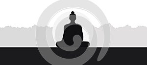 Black silhouette of the Buddha sitting on the mountain.