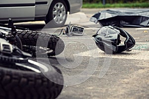 Motorcycle and helmet on the street after dangerous traffic incident