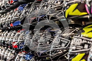 Motorcycle helmets displayed on a wall of a motorsports retailer photo