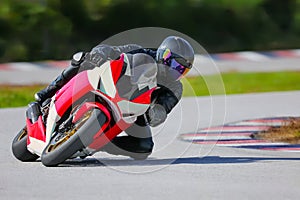 Motorcycle leaning into a fast corner on race track