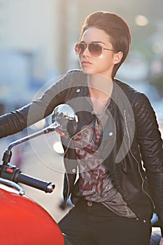 Motorcycle, leather and biker in city with sunglasses for travel, transport or road trip as rebel. Fashion, street and