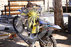 Motorcycle, man and sport for outdoor training, competition and adventure on trailer. Extreme sports, adrenaline and