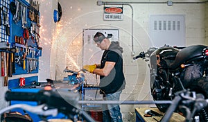 Motorcycle mechanic using a grinder