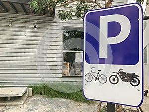 Motorcycle parking spot sign in front of store photo