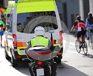 Motorcycle police while escorting an ambulance in the traffic