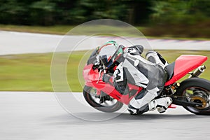 Motorcycle practice leaning into a fast corner on track