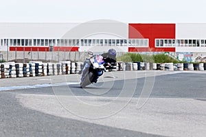 Motorcycle practice leaning into a fast corner on track