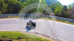 Motorcycle ridding in himalayan mountain twisty road at morning from low angle