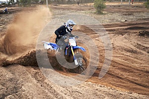 Motorcycle rider bogged down in loose sand cornering