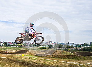A motorcycle rider participates in a motocross race. Jumps on the trampoline.