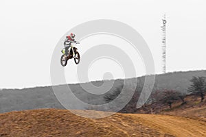 Motorcycle rider soaring through the sky on a dirt bike