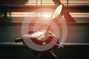 Motorcycle scooter.scooter with headlight, handlebar and mirrors against blue sky. Against the background of the setting sun