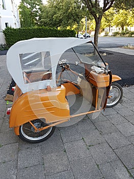 Motorcycle on three wheels with a cabin for the passenger