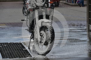 Motorcycle washing with cleaning foam. Pure moto bike. Enduro motorcycle. Cleanliness of vehicles. Car wash professional