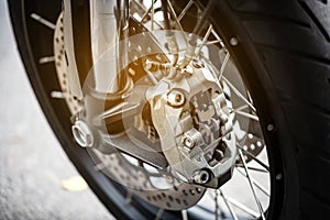Motorcycle wheel with ABS brakes, selective focus.