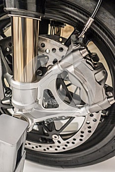 Motorcycle wheel with dic brakes and shocks close up