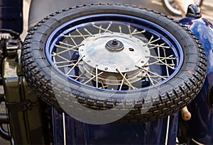 Motorcycle wheel. Rim of a spoke on a background of a blue motorcycle retro techno background