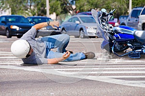 Motorcycle wreck at a busy intersection photo