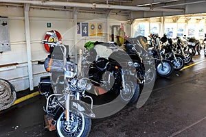 Motorcycles lined up in a ferry on a sunny day